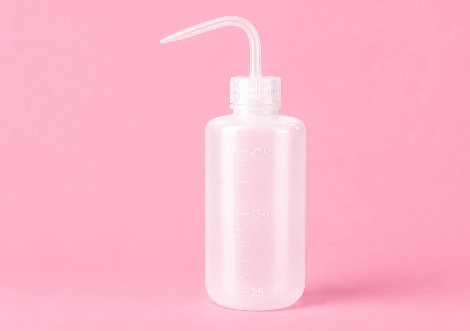 A translucent white plastic watering bottle with a clear curved nozzle, shown against a solid pink background. 250ml or 500ml Pink/White Tattoo Wash Bottle Bratty Beauty XO