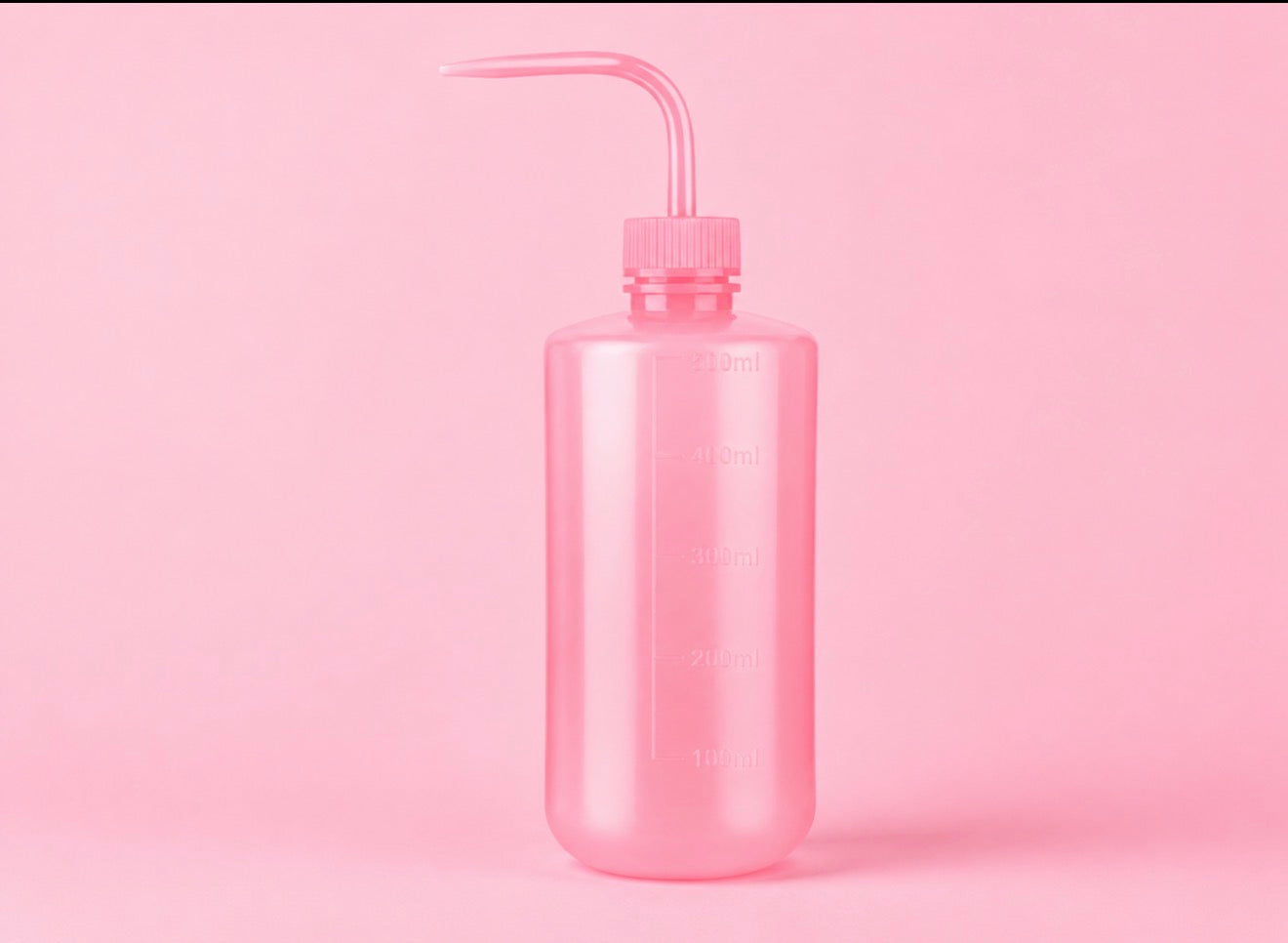 A translucent pink plastic watering bottle with a long curved nozzle, shown on a solid pink background250ml or 500ml Pink/White Tattoo Wash Bottle Bratty Beauty XO