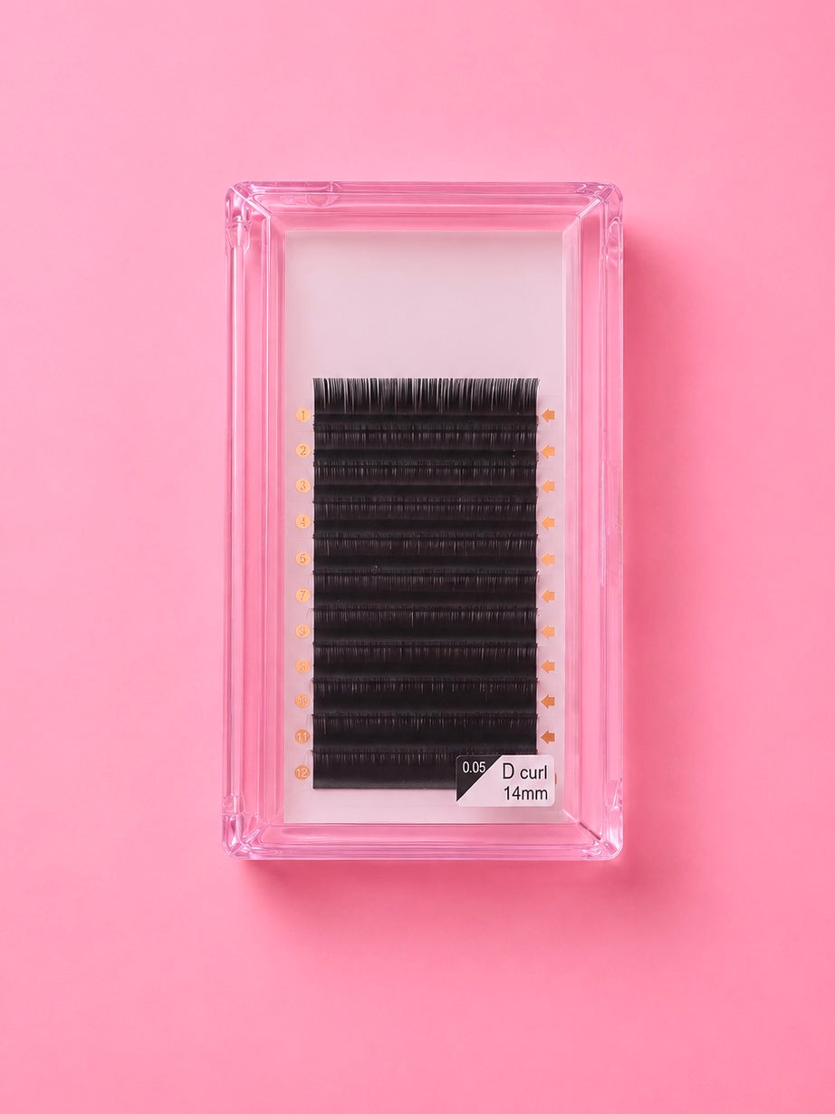 A pack of black false eyelashes in a clear pink plastic tray, displayed on a solid pink background.Bratty Beauty XO Matte Black 0.5D Curl 14mm Lash Extension Tray