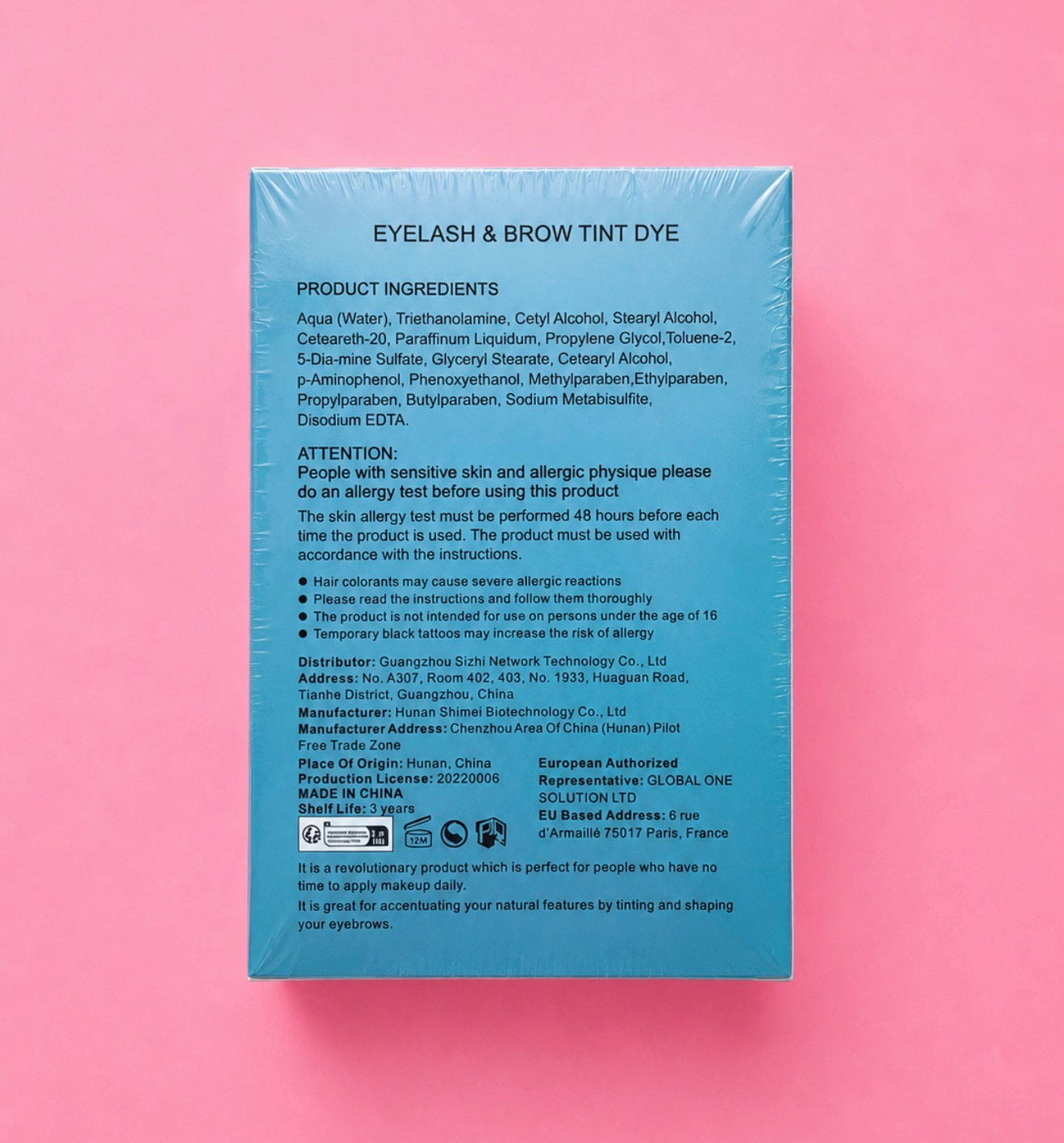 The back of a light blue rectangular box for an eyelash and brow tint, photographed against a pink background. The box contains product ingredients, usage instructions, and regulatory text in black print.Professional Eyelash & Brow Tint Dye Kit Bratty Beauty XO