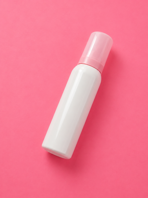 A blank white cosmetic spray bottle with a translucent pink cap, placed diagonally on a solid pink background. 100 ml Luxury Whipped Lash Shampoo Cleanser | Deep Cleansing & Oil-Free Formula bratty beauty xo