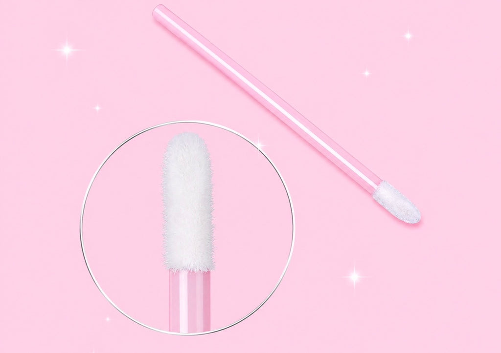 A pink makeup sponge applicator with a white fluffy tip, shown on a pink background with a circular zoom-in detail of the sponge headPink or Black Disposable Lip Brushes/ Lip Wands | 500 or 700 pcs