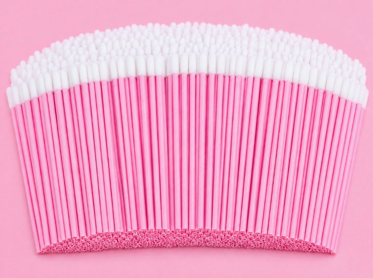 A large bundle of pink paper straws with white cotton swab tips, arranged in a curved fan shape on a solid pink backgroundPink or Black Disposable Lip Brushes/ Lip Wands | 500 or 700 pcs