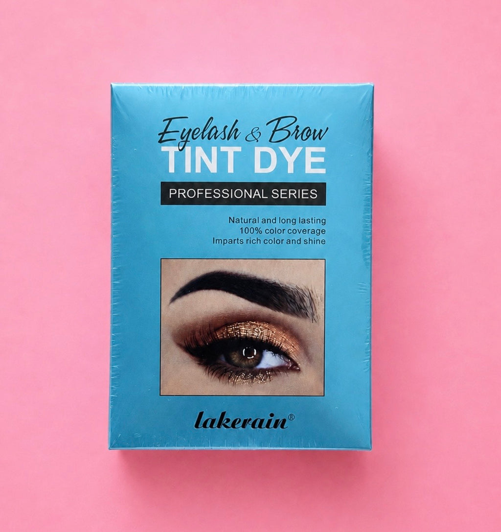 A rectangular box of Lakerain Eyelash & Brow Tint Dye Professional Series, featuring a bright blue packaging with a sample eye makeup photo, set against a solid pink background.Professional Eyelash & Brow Tint Dye Kit Bratty Beauty XO