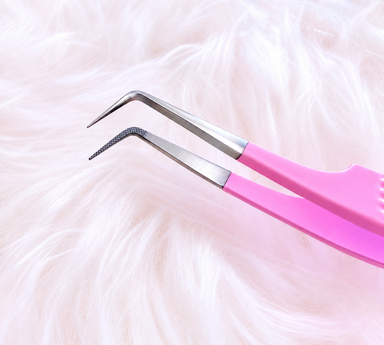 Pink-handled metal tweezers with angled tips, resting on a soft white faux-fur surface.Boss Babe Fanning Tweezer bratty beauty xo volume lash tweezer 