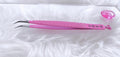Pink curved tweezers with a textured grip and 'Beauty Beauty' branding, displayed on a white faux fur surface next to a small pink heart-shaped object.Boss Isolation Tweezer bratty beauty xo volume lash tweezer